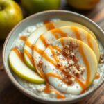 A jar of caramel apple overnight oats topped with fresh apple slices, caramel drizzle, and a sprinkle of cinnamon.
